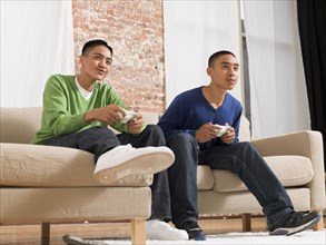 Mixed race brothers playing video games together