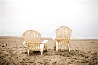 Empty lawn chairs on beach