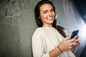 Caucasian woman using cell phone in tunnel