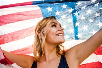 Caucasian teenage girl holding American flag