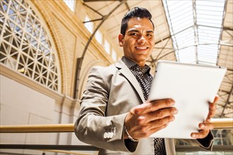 Hispanic businessman using digital tablet