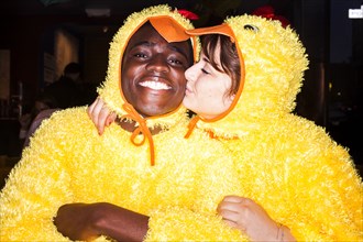 Couple kissing in chicken costumes