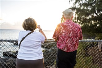 Older couple admiring scenic view of ocean