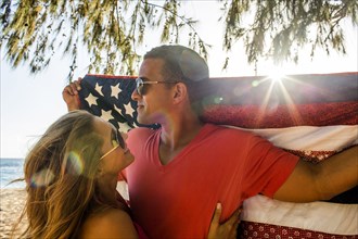 Couple holding American flag quilt