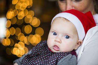 Close up of Caucasian baby girl wearing Santa hat