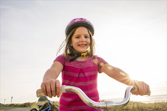 Caucasian girl riding bicycle outdoors