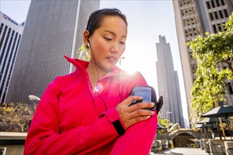 Runner using cell phone in city
