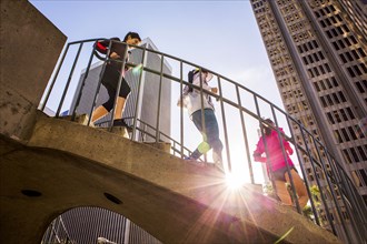Low angle view of women running on urban staircase
