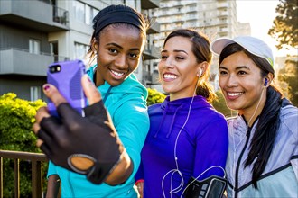Runners taking selfie on in city