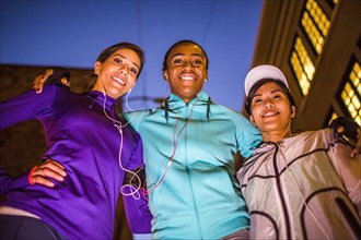 Low angle view of runners smiling at night