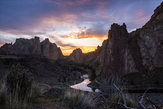 Creek reflecting sunset sky in desert landscape