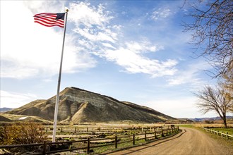 Low angle view of American flag over dirt road