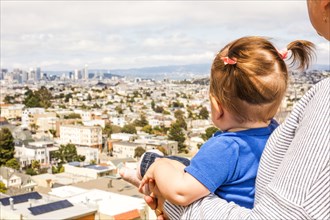 Caucasian mother and daughter admiring San Francisco cityscape