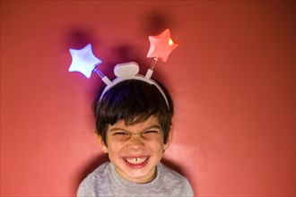 Mixed race boy wearing headband with stars