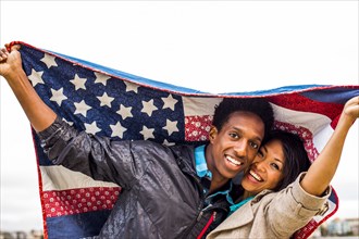 Couple holding American flag quilt outdoors