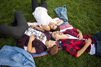 Friends laying in grass