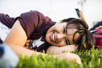Smiling woman laying in grass