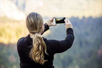 Caucasian woman photographing Yosemite National Park