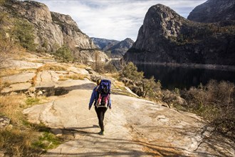 Caucasian mother carrying daughter in Yosemite National Park