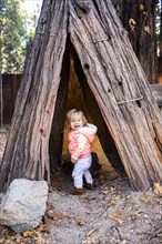 Caucasian baby girl playing in teepee