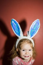 Caucasian baby girl wearing bunny ears