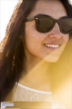 Mixed race woman wearing sunglasses