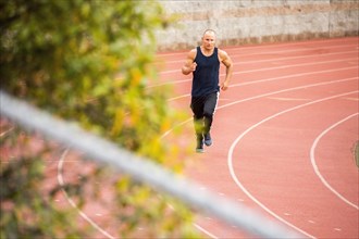 Caucasian man running on track