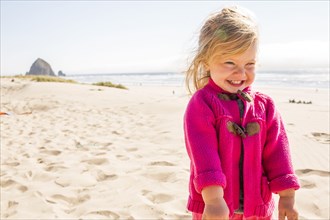 Caucasian girl smiling on beach