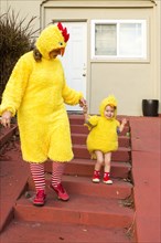 Caucasian mother and daughter wearing chicken costumes