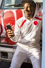 Laughing Black man posing for cell phone selfie