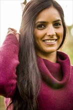 Portrait of smiling Indian woman wearing sweater