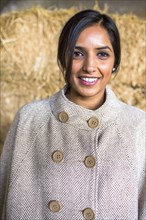 Portrait of smiling Indian woman wearing poncho