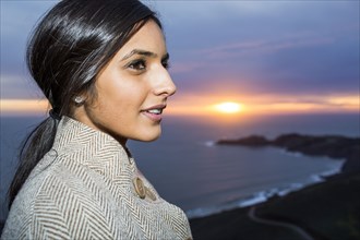 Portrait of Indian woman near ocean at sunset