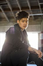 Portrait of serious androgynous Asian man