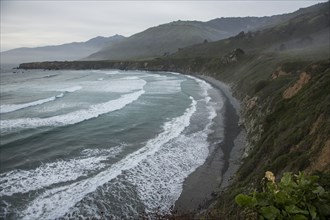 Scenic view of ocean beach and cliffs