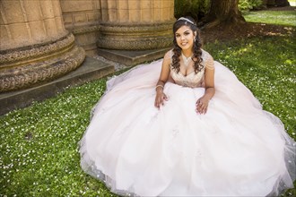 Portrait of smiling Hispanic girl wearing gown