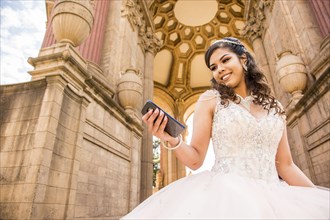 Smiling Hispanic girl texting on cell phone