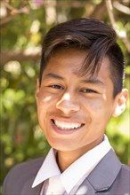 Portrait of smiling Hispanic boy wearing suit