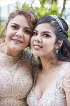 Portrait of smiling Hispanic mother and daughter