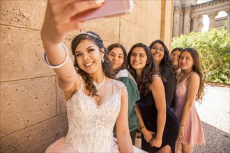 Hispanic girls posing for cell phone selfie