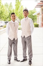 Hispanic boys wearing suits