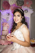 Hispanic girl wearing gown drinking beverage with straw