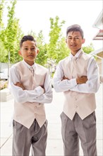 Portrait of confident Hispanic boys wearing suits