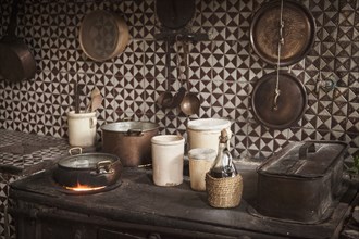 Pots and pans on cast iron stove in kitchen