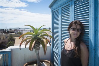 Caucasian woman standing on urban balcony