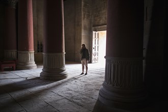 Caucasian tourist standing in ancient building