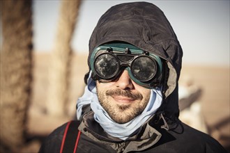 Caucasian traveler wearing goggles and gear