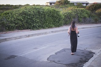 Caucasian woman walking on empty road