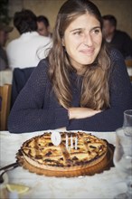 Caucasian woman with birthday cake in restaurant