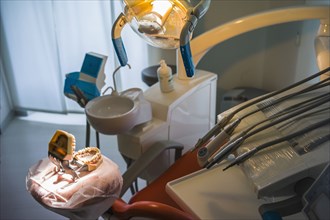 Empty chair and dentures in office of dentist
